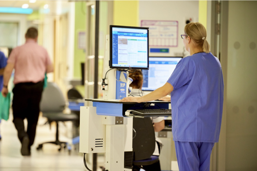 A medical professional working at a computer